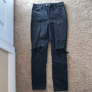 Black mom jeans with a hole in the knee